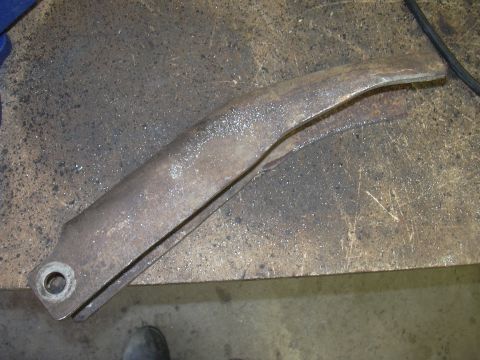 1991 Ford Bronco - Close-up of a weathered metal part, likely from a vehicle's suspension system.