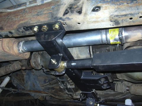 1991 Ford Bronco - Custom suspension components and exhaust system visible from underneath a vehicle, with yellow labels on the exhaust pipe.