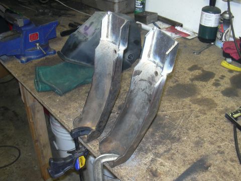 1991 Ford Bronco - Metal parts being worked on in a garage setting, with tools and equipment visible.