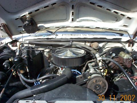 1985 Ford Bronco - Close-up view of the engine compartment, showing the air filter and surrounding mechanical parts.