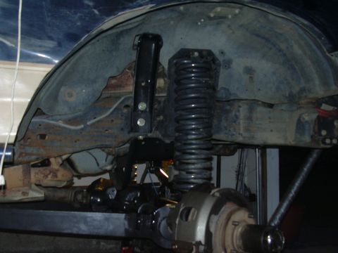 1991 Ford Bronco - Close-up view of a vehicle's rear axle and suspension system, with visible rust and wear on the components.