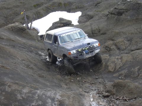 1991 Ford Bronco - This 1991 Ford Bronco tackles a challenging off-road course with steep inclines and rocky obstacles.