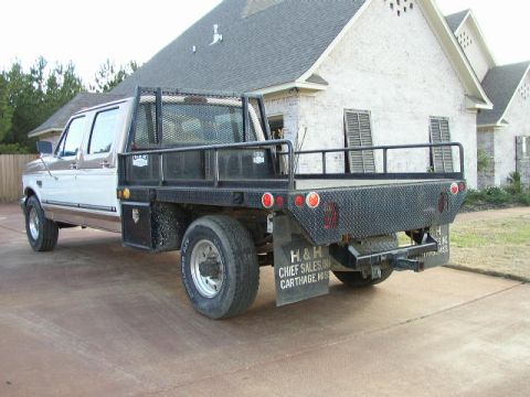1995 Ford Bronco - This crew cab flatbed truck, likely a Ford F-350, is shown from a 3q-front angle. The mud flaps indicate it is from H & H Chief Sales in Ca…
