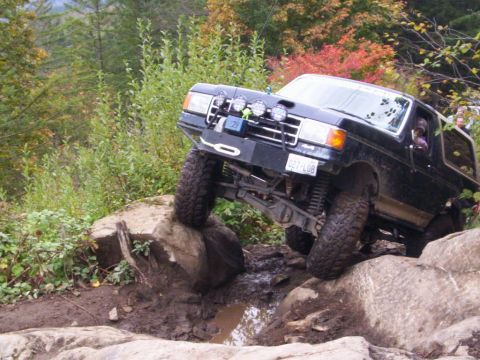 1991 Ford Bronco - This 1991 Ford Bronco navigates a challenging rocky terrain with its tires angled on large boulders.