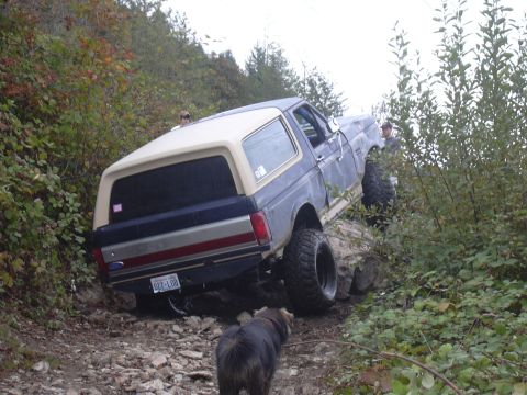 1991 Ford Bronco - A lifted Ford Bronco navigates a rocky trail, demonstrating its off-road capabilities.