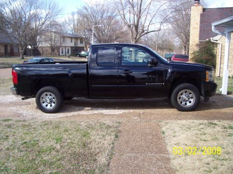 2008 Chevrolet Silverado 1500 - Black Chevrolet Silverado pickup truck seen from the side, parked in a residential driveway.