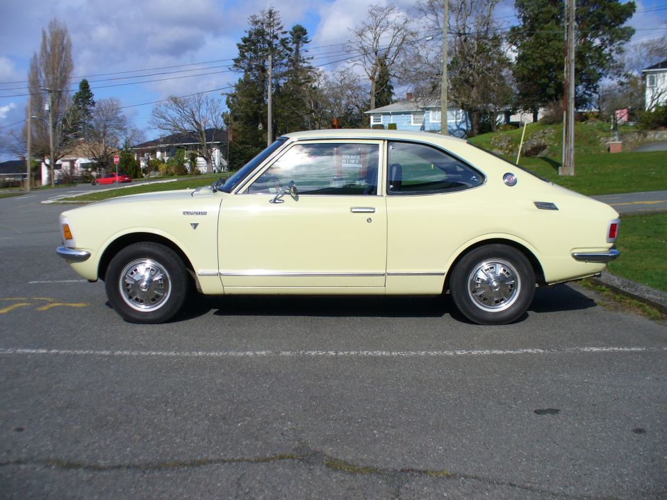Side profile of pale yellow Toyota coupe