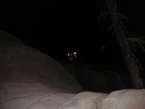 1991 Ford Bronco - A vehicle is visible in the distance at night, illuminated by its lights.