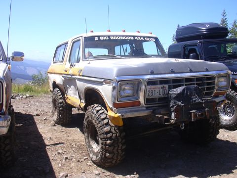 1991 Ford Bronco - Two Broncos 4x4 Club members pose their modified vehicles on a sunny day.