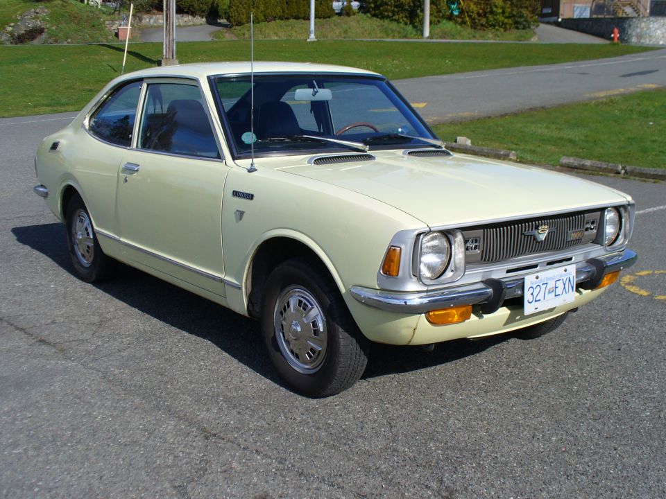 Front three-quarter view of pale yellow Toyota coupe with BC plate 327 EXN
