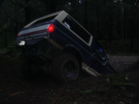 1991 Ford Bronco - This 1991 Ford Bronco appears to be stuck off-road in a muddy, wooded area.