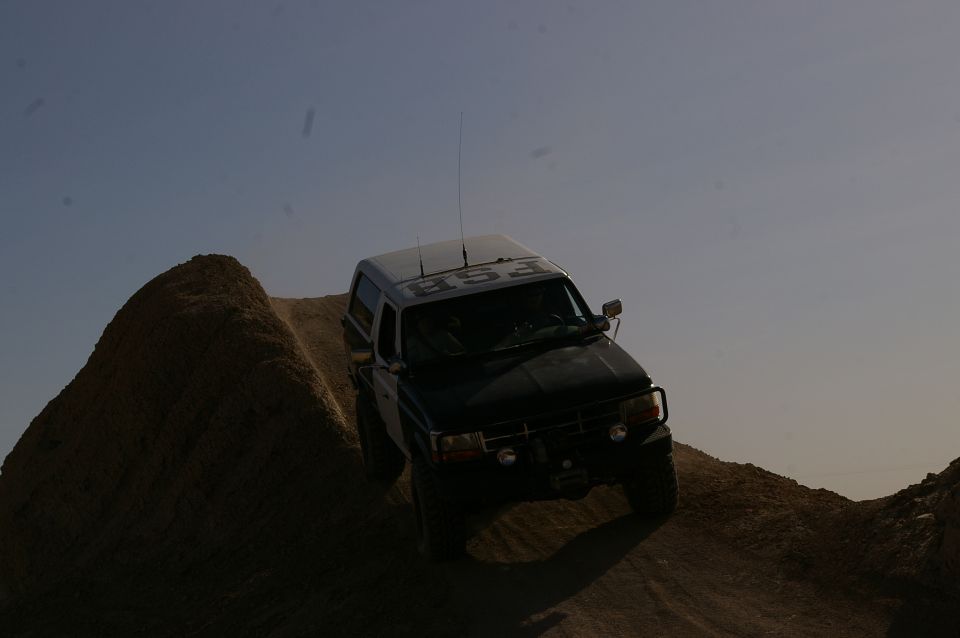 1992 Ford Bronco climbing a steep dirt hill, text 'FSB' on roof