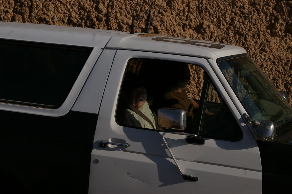Side view of a 1986 Ford Bronco with two occupants