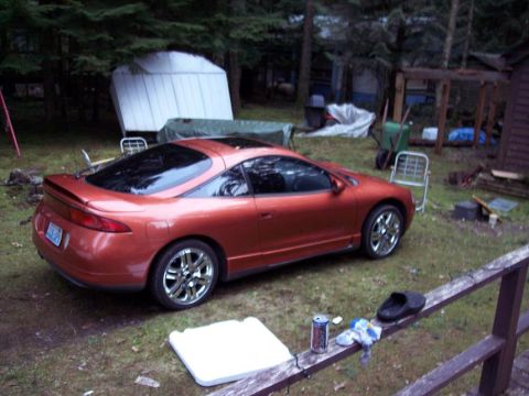 1995 Mitsubishi Eclipse - This 1995 Mitsubishi Eclipse coupe is parked in a wooded area.