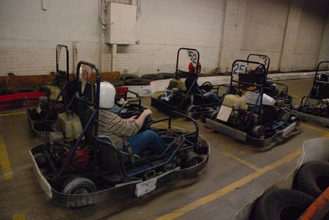 1993 Ford Probe - Several go-karts are lined up on a track, with drivers wearing helmets and racing suits.
