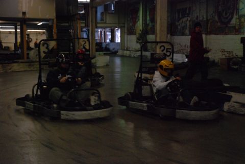 1993 Ford Probe - Indoor go-kart racing scene with multiple drivers on the track.
