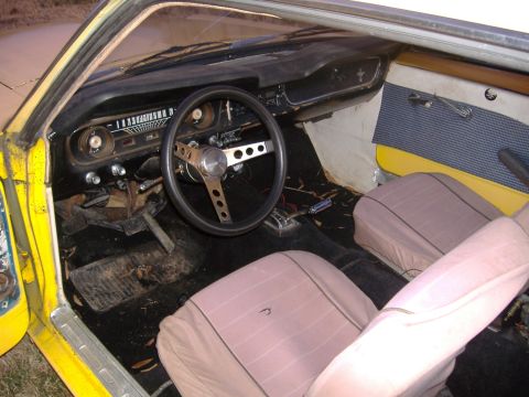 1987 Ford Crown Victoria LTD - The interior of a vintage car shows its age with worn seats and a dated dashboard.