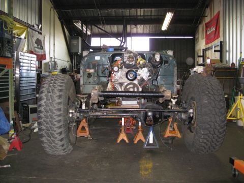1994 Jeep YJ - This Jeep YJ is undergoing a build, with its chassis elevated and engine accessible for work.