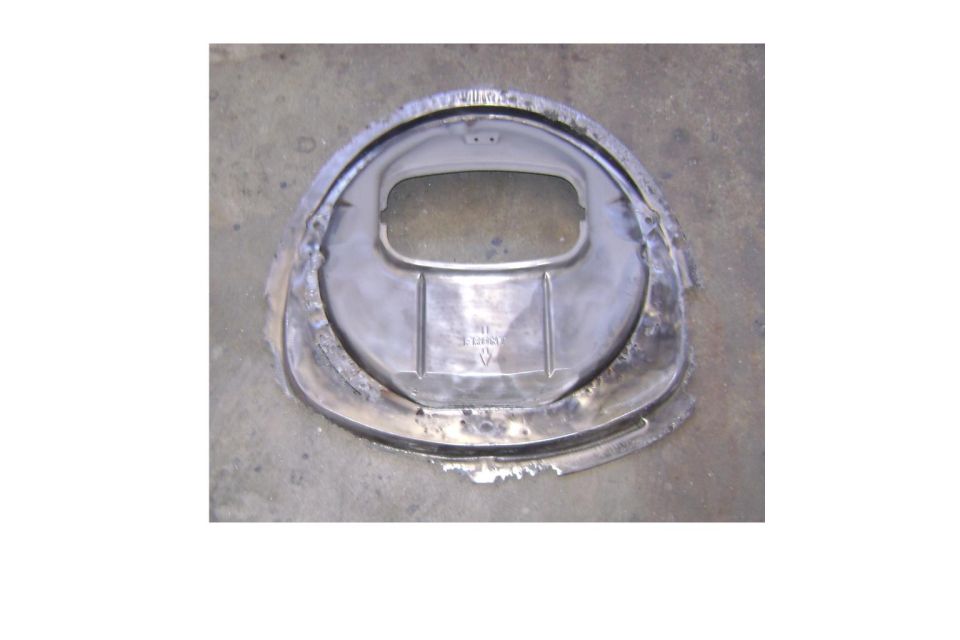 Bare metal automotive backing plate or dust shield on gravel