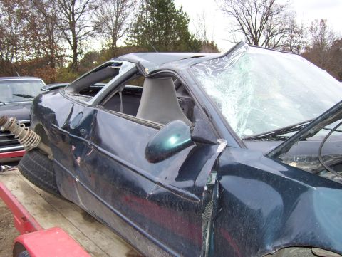 1996 Ford Probe - This 1996 Ford Probe has sustained significant damage to its roof and windshield.