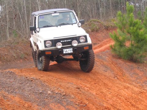 1987 Suzuki Samurai - This 1987 Suzuki Samurai navigates a challenging off-road course with a driver behind the wheel.
