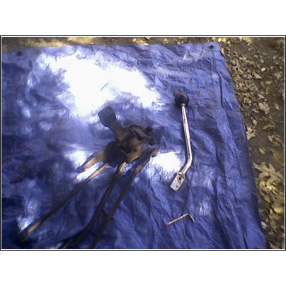 1972 Ford Ranchero - Transmission shifter linkage and knob laid out on a blue tarp.
