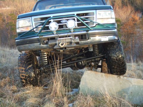 1996 Ford Bronco - 1996 Ford Bronco front end shown during an off-road obstacle course.