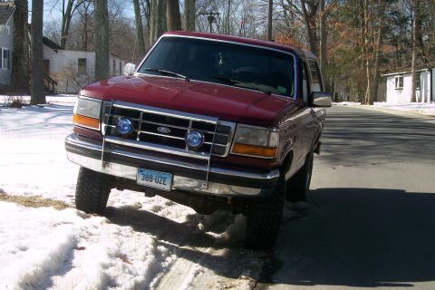 1993 Ford Bronco - Red 1993 Ford Bronco parked on a residential street in the snow.