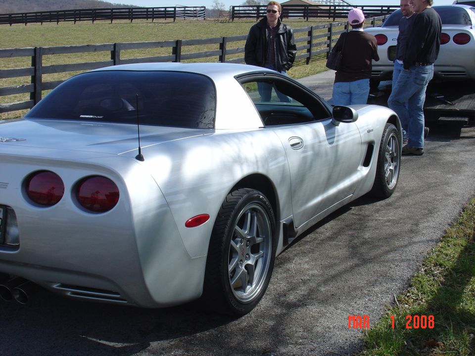 Silver Chevrolet Corvette C5, rear view, showing dual taillights and quad exhaust pipes