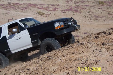 1990 Ford Bronco - This Ford Bronco is navigating a challenging, rocky desert landscape.