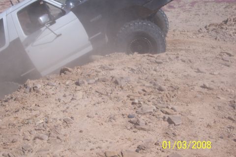 1990 Ford Bronco - 1990 Ford Bronco navigating a challenging off-road trail.