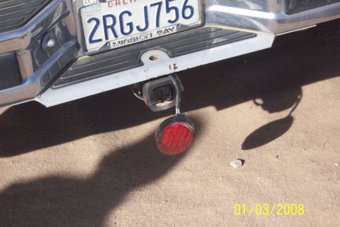 1990 Ford Bronco - Close-up of a vehicle's rear bumper and trailer hitch assembly.