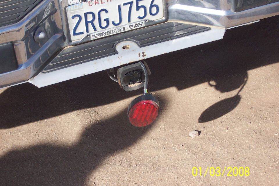 Rear bumper with California license plate 2RGJ756 and trailer hitch with red light