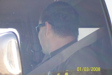 1990 Ford Bronco - View from inside a vehicle shows a driver wearing sunglasses and a seatbelt.