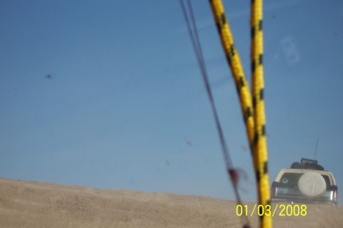 1990 Ford Bronco - This 1990 Ford Bronco is seen from behind, driving through a desert landscape.