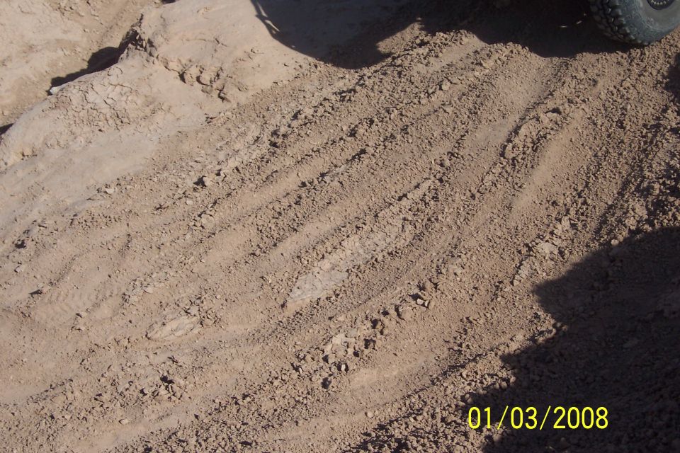 Tire tracks in dirt with date stamp 01/03/2008