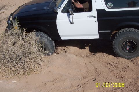 1990 Ford Bronco - This 1990 Ford Bronco navigates a challenging off-road course with steep inclines and loose dirt.
