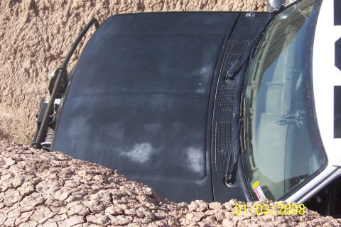 1990 Ford Bronco - This 1990 Ford Bronco appears to be stuck or abandoned, partially submerged in dry, cracked earth.