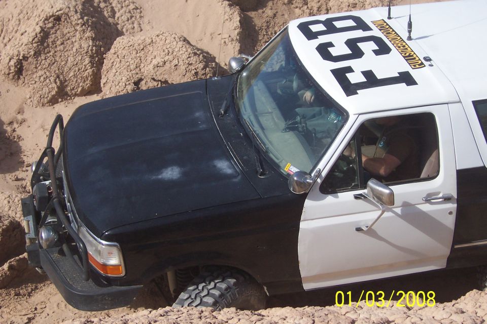 1990 Ford Bronco with FSB markings stuck in sand