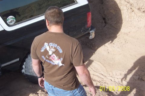 1990 Ford Bronco - Man watches as a 1990 Ford Bronco gets stuck in the sand.