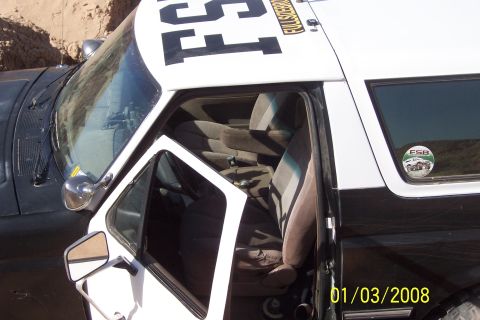 1990 Ford Bronco - Interior view of a 1990 Ford Bronco, its seats and door, with exterior markings visible.