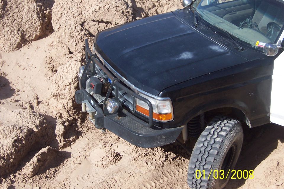 1990 Ford Bronco front end in sand with bull bar and winch