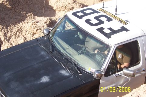 1990 Ford Bronco - This truck, marked 'FSB', appears to be off-road in sandy terrain.