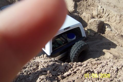 1990 Ford Bronco - This 1990 Ford Bronco is stuck in the sand, with its rear tire visible.