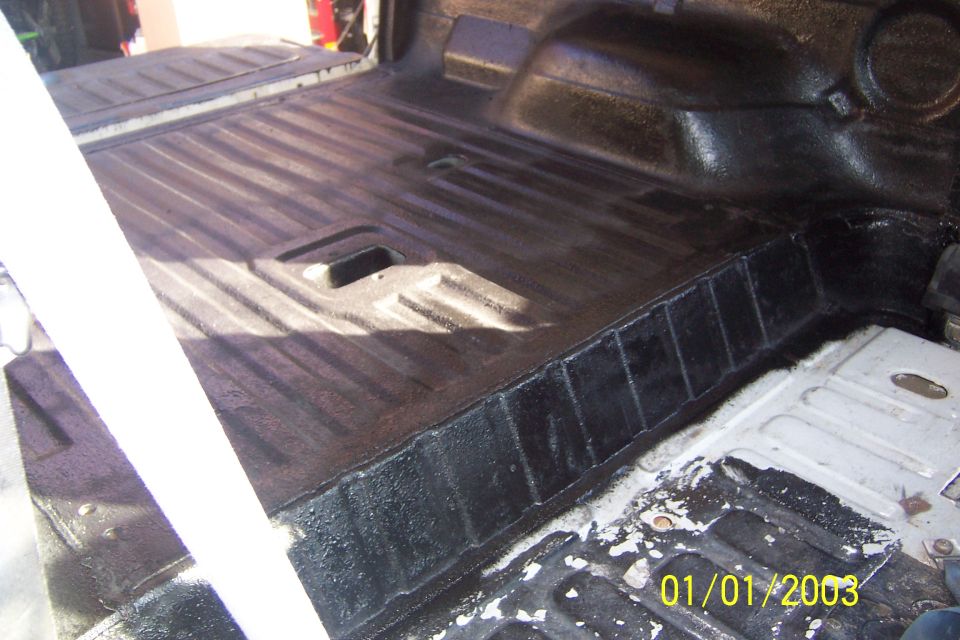 Bed of a vehicle with protective coating applied.