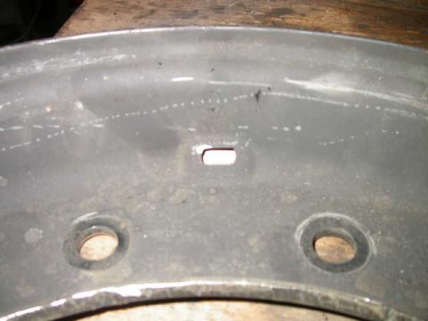 1990 Ford Bronco - Annoying oblong hole for military valve stem. Needs to be drilled out to .453" (29/64") to accept civilian valve stem.