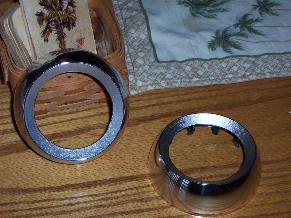 Two chrome rings with textured inner edges on a wooden surface.