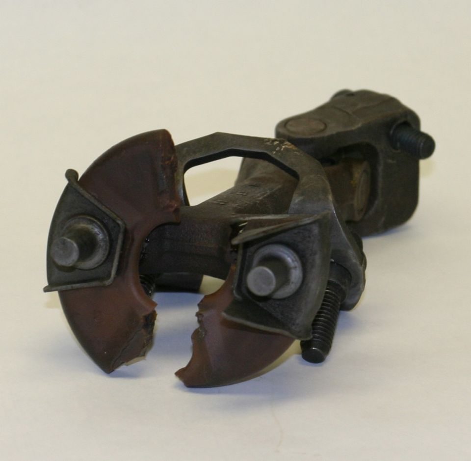 Steel jack head with split red-brown painted clamp jaws on white background