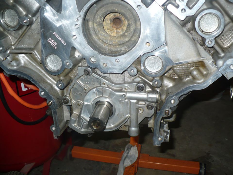 Front of an aluminum V-engine block with oil pump on a stand