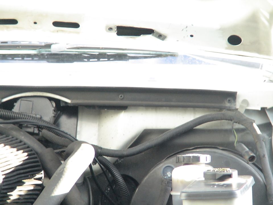 Engine bay of a 1993 Ford C-350 (Centurion Conversions) showing wiper motor, hoses, and fluid reservoirs.